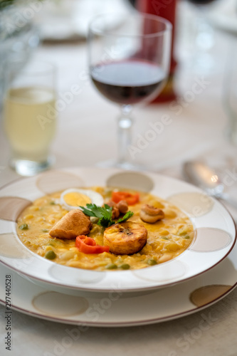 Typical dish of Ecuadorian food  soup based on cod fish  with milk and many grains  served with fried plantain  fried wheat dough and hard-boiled egg