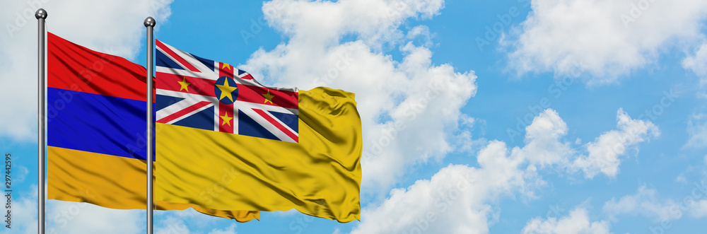 Armenia and Niue flag waving in the wind against white cloudy blue sky together. Diplomacy concept, international relations. Armenia and Niue flag waving in the wind against white cloudy blue sky together. Diplomacy concept, international relations.