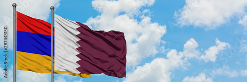 Armenia and Qatar flag waving in the wind against white cloudy blue sky together. Diplomacy concept, international relations.