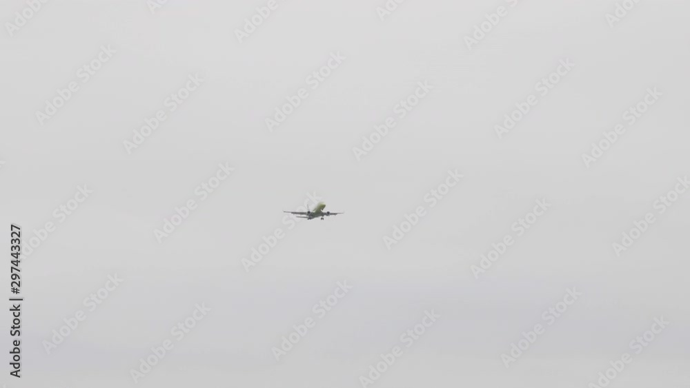 The Commercial passenger airplane flying overhead on sunny day. The Commercial passenger airplane flying overhead on sunny day.