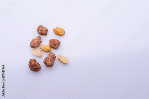 Peanuts praline sweet on dark grey background, top view, soft light, copy space