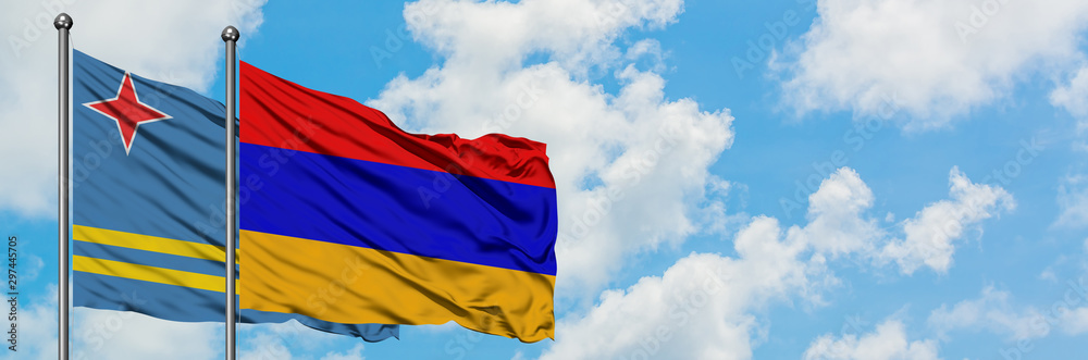 Fototapeta premium Aruba and Armenia flag waving in the wind against white cloudy blue sky together. Diplomacy concept, international relations.