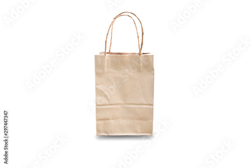 Brown paper bag with handles isolated on white background in vertical format. Room for your advertising text. Front view.
