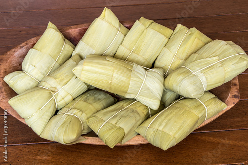 Pamonha. Brazilian Corn Snack on wooden basket in Brazil