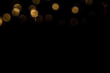 Abstract gold bokeh with black background