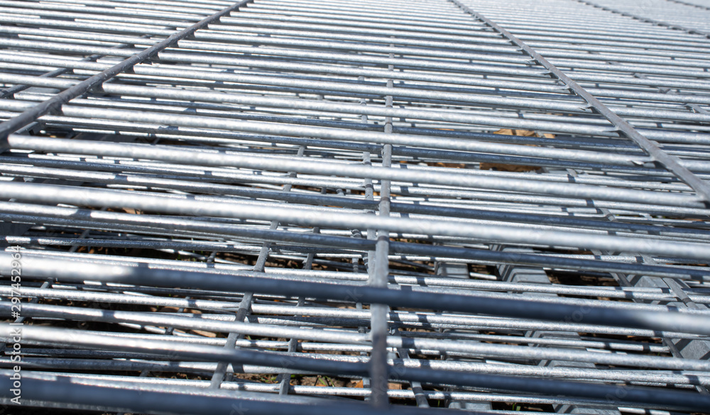 Metal grid industrial background in perspective.Construction art and texture.Metal material.Urban style concept.Outdoor renovation.Building the wall.