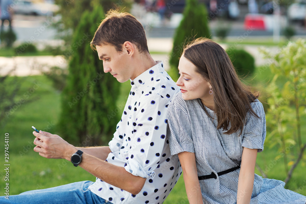 Beautiful couple in love dating outdoors and smiling. Girl persuades her boyfriend to take a picture of herself together. Selfie. Keep a moment in mind. Happy time together Beautiful couple in love dating outdoors and smiling. Girl persuades her boyfriend to take a picture of herself together. Selfie. Keep a moment in mind. Happy time together