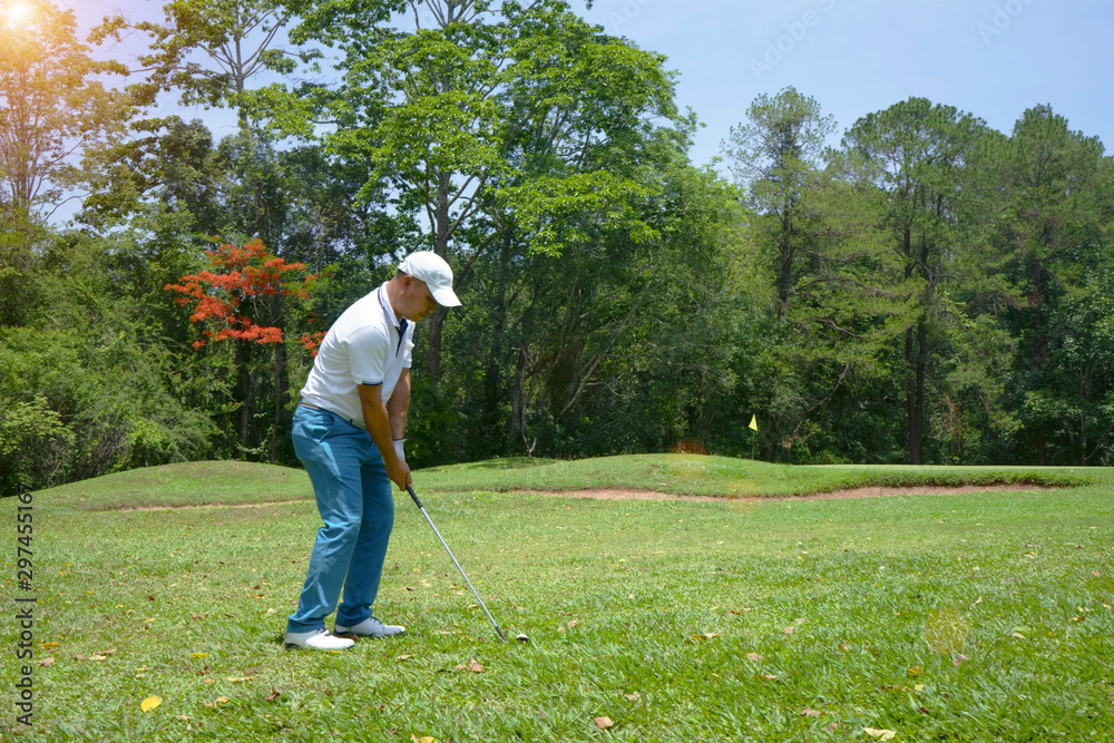 Blurred golfer playing golf in beautiful golf course in the evening golf course with sunshine in thailand Blurred golfer playing golf in beautiful golf course in the evening golf course with sunshine in thailand