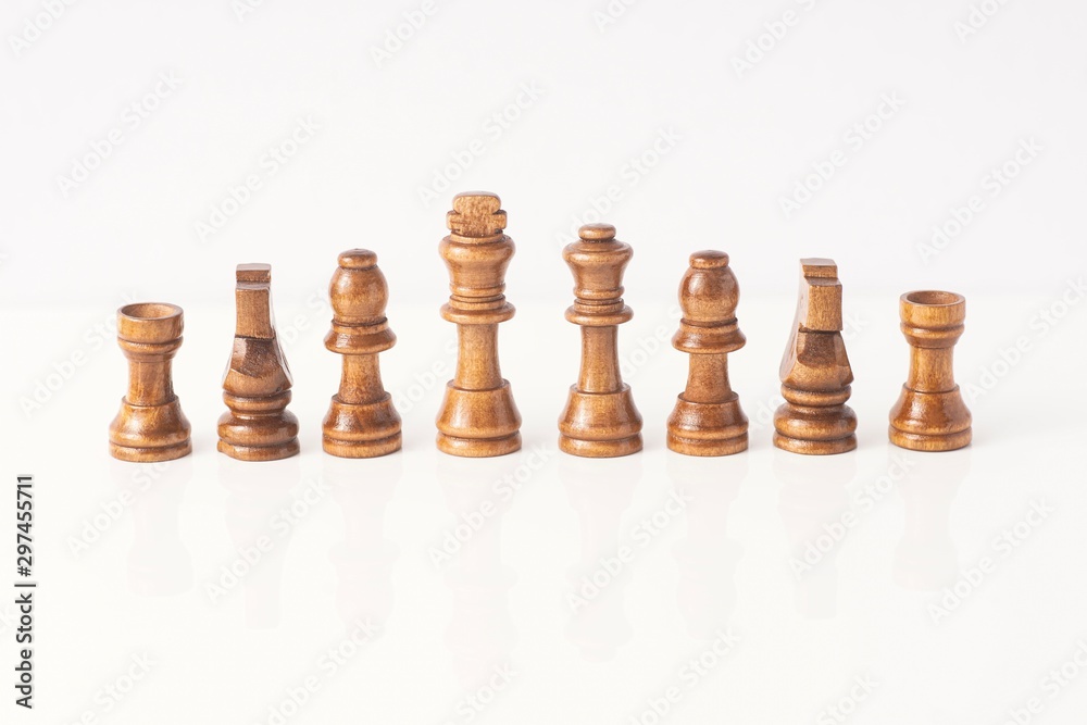wooden chess pieces isolated against white wooden chess pieces isolated against white