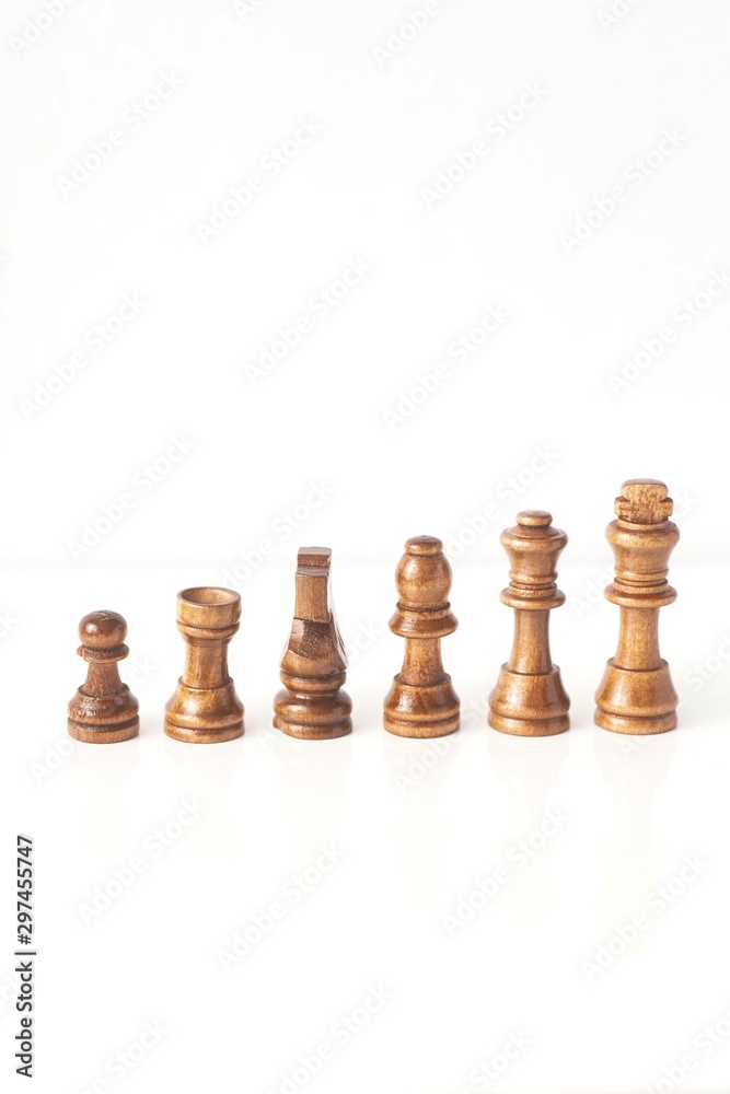 wooden chess pieces isolated against white wooden chess pieces isolated against white