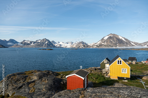 A few colourful houses overseing a beautiful view of glaciers. 