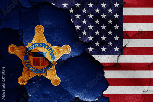 flags of United States Secret Service and USA painted on cracked wall