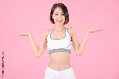sport woman standing open hands and showing muscle bodybuilding on pink backgrounds, fitness concept, sport concept © I Believe I Can Fly