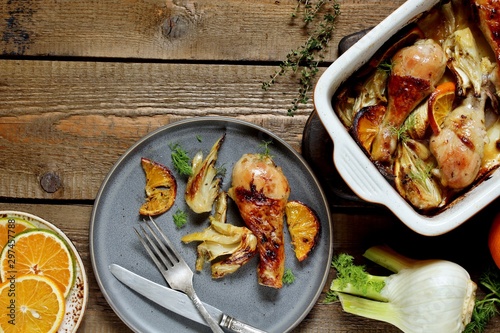 dish with fennel. Baked chicken drumsticks with fennel and oranges. festive dish, popular in the Mediterranean. Keto diet dish. ceramic baking dish. top view. Flatlay