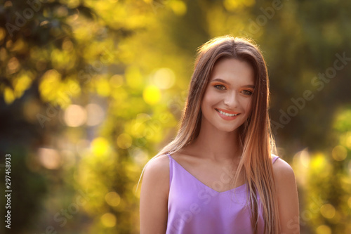 Fototapeta Naklejka Na Ścianę i Meble -  Beautiful young woman posing outdoors on sunny day