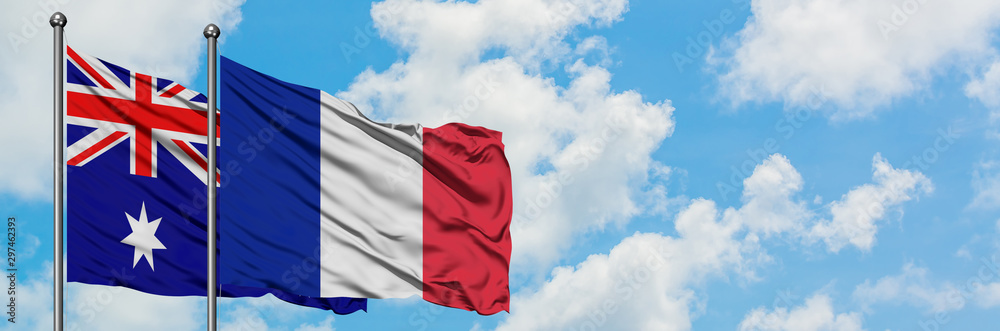 Australia and Reunion flag waving in the wind against white cloudy blue sky together. Diplomacy concept, international relations. Australia and Reunion flag waving in the wind against white cloudy blue sky together. Diplomacy concept, international relations.