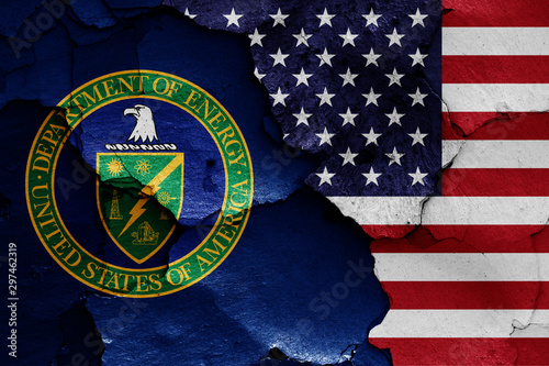 flags of Department of Energy and USA painted on cracked wall