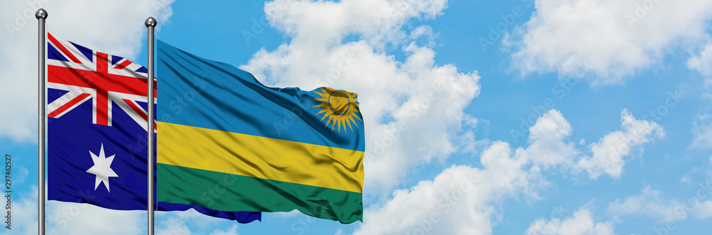 Australia and Rwanda flag waving in the wind against white cloudy blue sky together. Diplomacy concept, international relations. Australia and Rwanda flag waving in the wind against white cloudy blue sky together. Diplomacy concept, international relations.