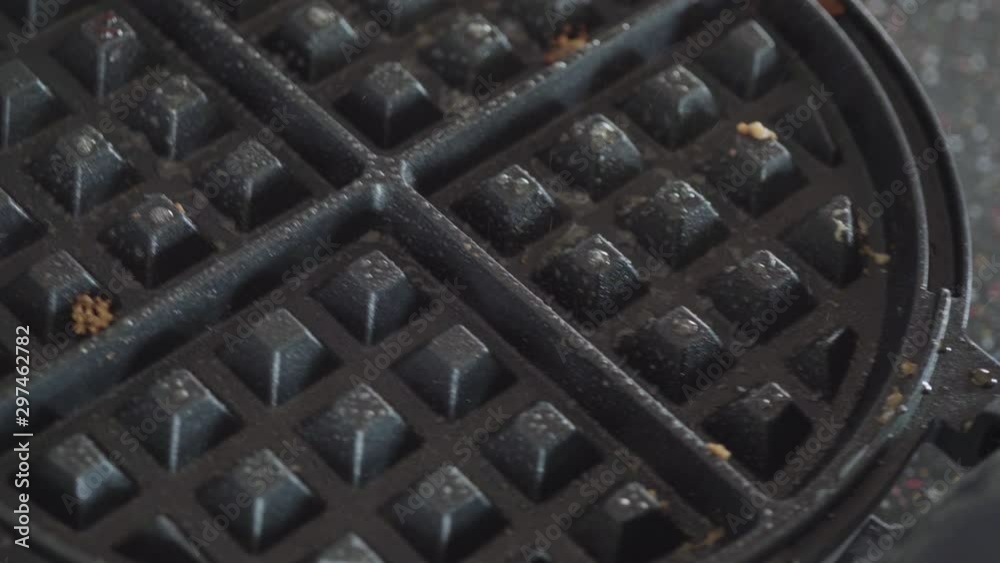 Making homemade waffles in an electric waffle maker. Making homemade waffles in an electric waffle maker.
