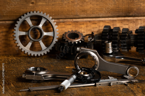 motorcycle engine parts on a workbench with some tools