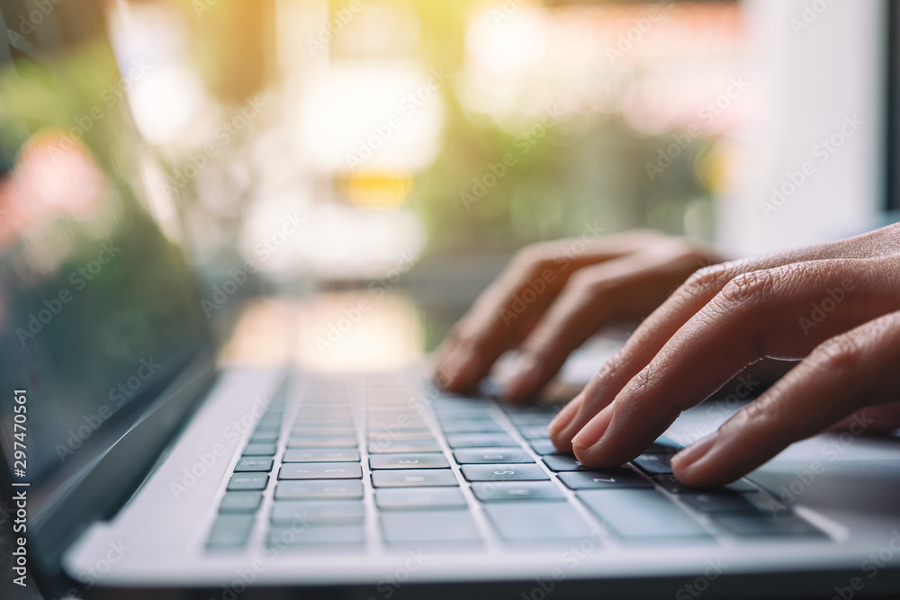Closeup image of a woman working and typing on laptop computer keyboard Closeup image of a woman working and typing on laptop computer keyboard