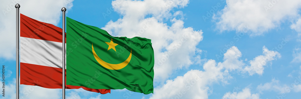 Austria and Mauritania flag waving in the wind against white cloudy blue sky together. Diplomacy concept, international relations. Austria and Mauritania flag waving in the wind against white cloudy blue sky together. Diplomacy concept, international relations.