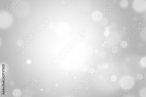 Silver light christmas background with white blur bokeh beautiful glow sparkle. Winter concept. Backdrop for ads, cosmetic, advertising design, beauty, promotion. Product display or montage