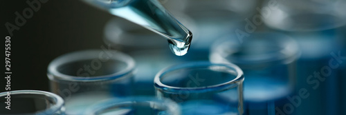 Bild auf Leinwand Test tube of glass overflows liquid solution potassium