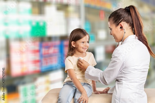 Young woman doctor with little girl in a hospital