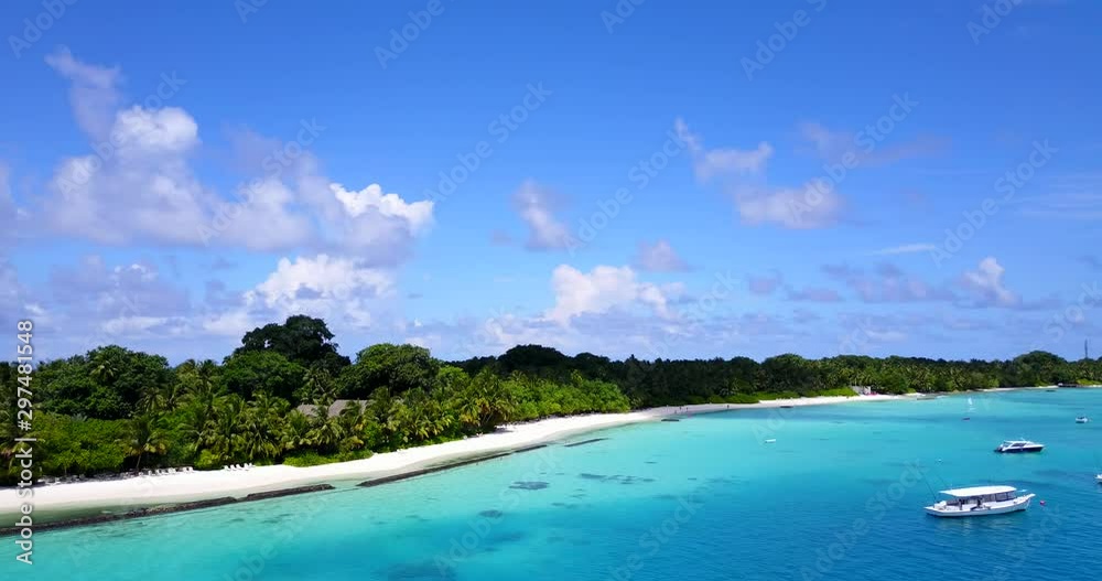 Flying point of view, tiny luscious tropical island in the middle of the ocean in the Maldives with luxurious yacht boats Flying point of view, tiny luscious tropical island in the middle of the ocean in the Maldives with luxurious yacht boats
