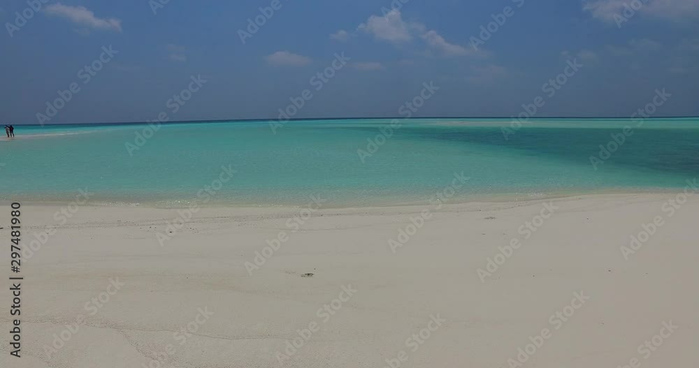 Tropical beach with white sand in Bali, Indonesia, with waves gently breaking on the shore Tropical beach with white sand in Bali, Indonesia, with waves gently breaking on the shore