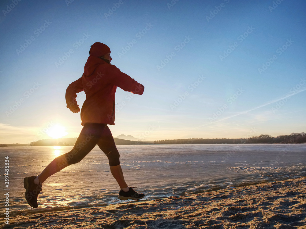 Woman run on the beah. Winter sports outdoor fitness concept.