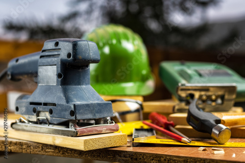 Electric sander for carpenter, carpentry tools on a work table. Construction industry, housework do it yourself. Stock photography.