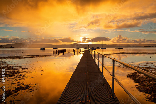 Sunset skies and water reflections from the jetty photo