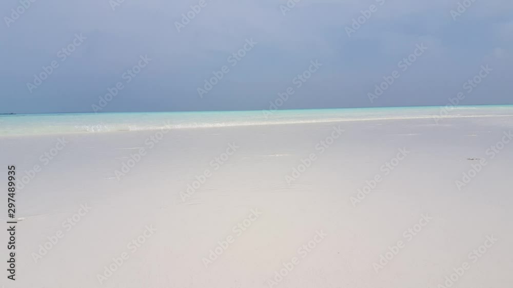 Tropical beach with white sand in Bali, Indonesia, with waves gently breaking on the shore, pov, point of view from the bottom Tropical beach with white sand in Bali, Indonesia, with waves gently breaking on the shore, pov, point of view from the bottom
