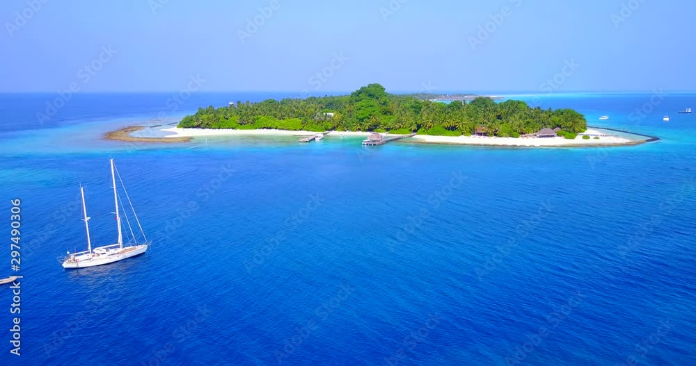 Sail boat off the coast of small tropical island in the caribbean Sail boat off the coast of small tropical island in the caribbean