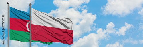 Azerbaijan and Poland flag waving in the wind against white cloudy blue sky together. Diplomacy concept, international relations.