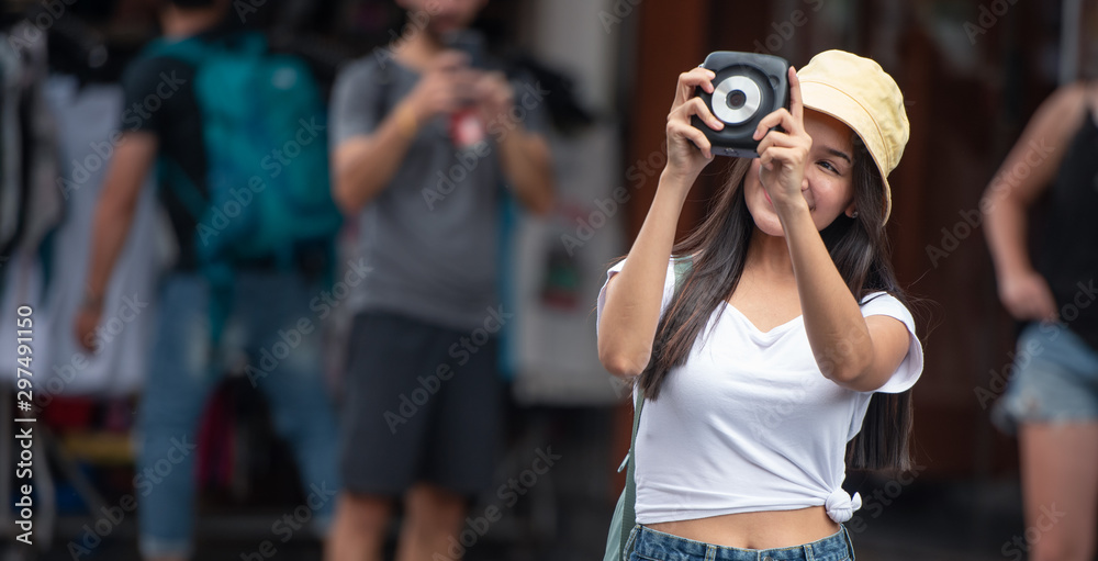 Happy traveller Asian woman on street market with camera, in Bangkok city of Thailand. Happy traveller Asian woman on street market with camera, in Bangkok city of Thailand.