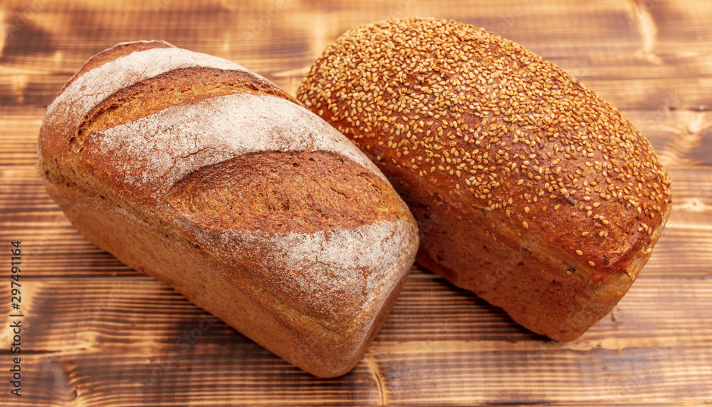 Fresh wheat bread on a wooden background