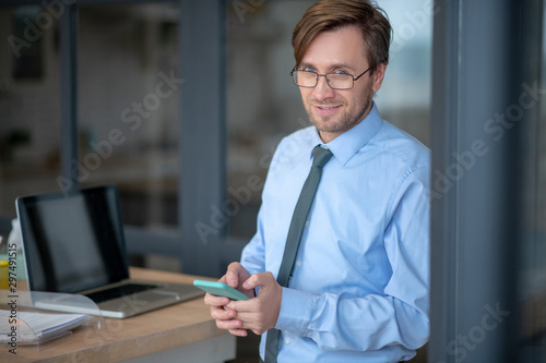 Young businessman smiling after making successful agreement
