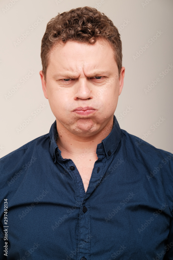Obraz premium Studio portrait of grumpy man