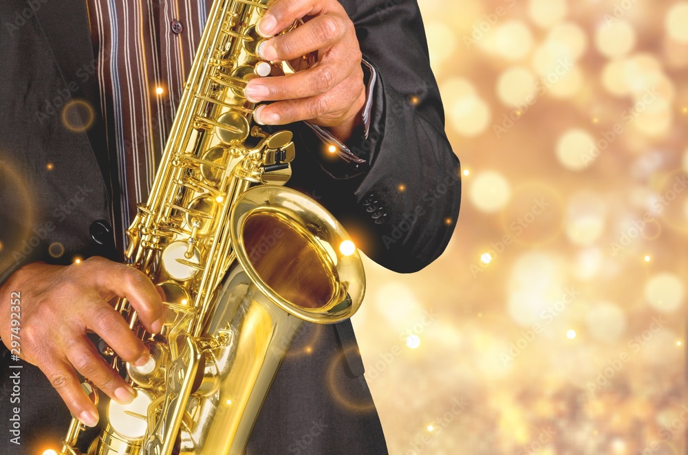 Obraz premium Saxophone player Saxophonist playing jazz music instrument