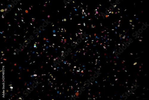 colorful party confetti flying in front of black