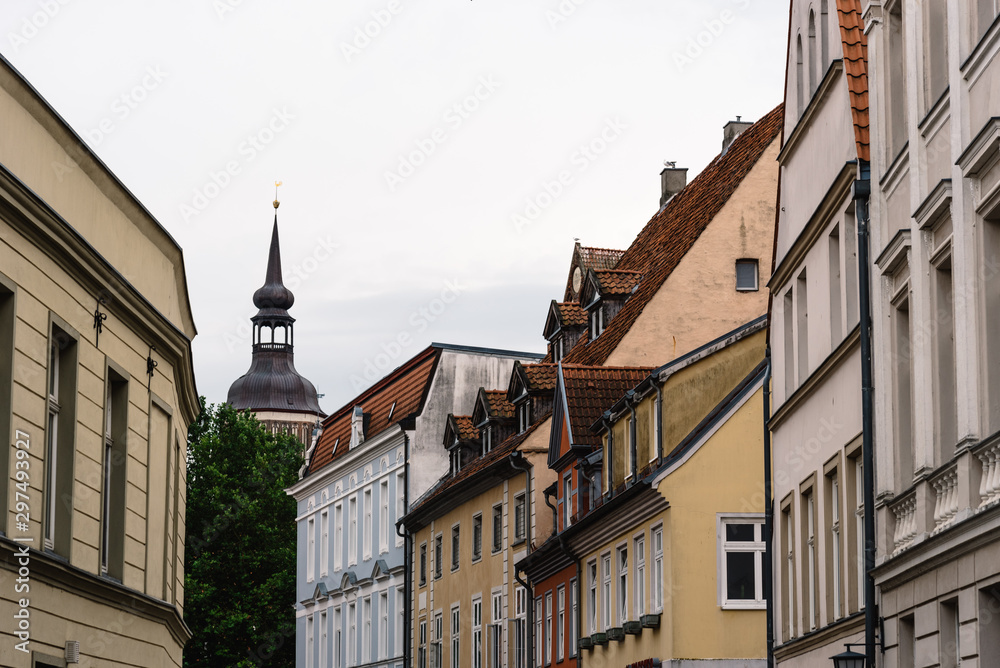 Traditional colorful houses and church tower in the old town of Stralsund