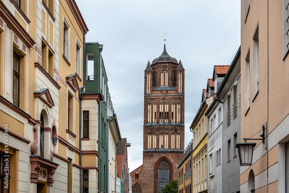 Traditional colorful houses and church tower in the old town of Stralsund