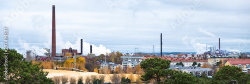 Fototapeta Cityscape, red brick buildings of an old factory, factory chimneys smoke