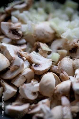 сooking onions and mushrooms on wok pan