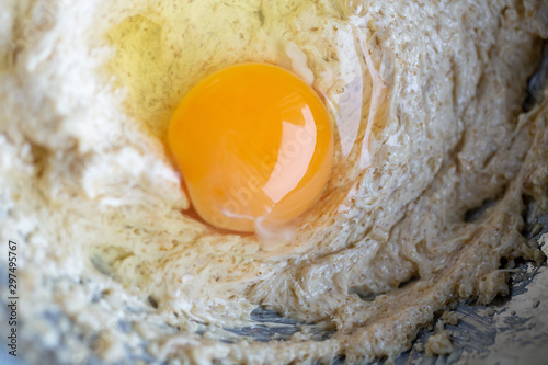 Broken egg and flour in a bowl. Food preparation concept