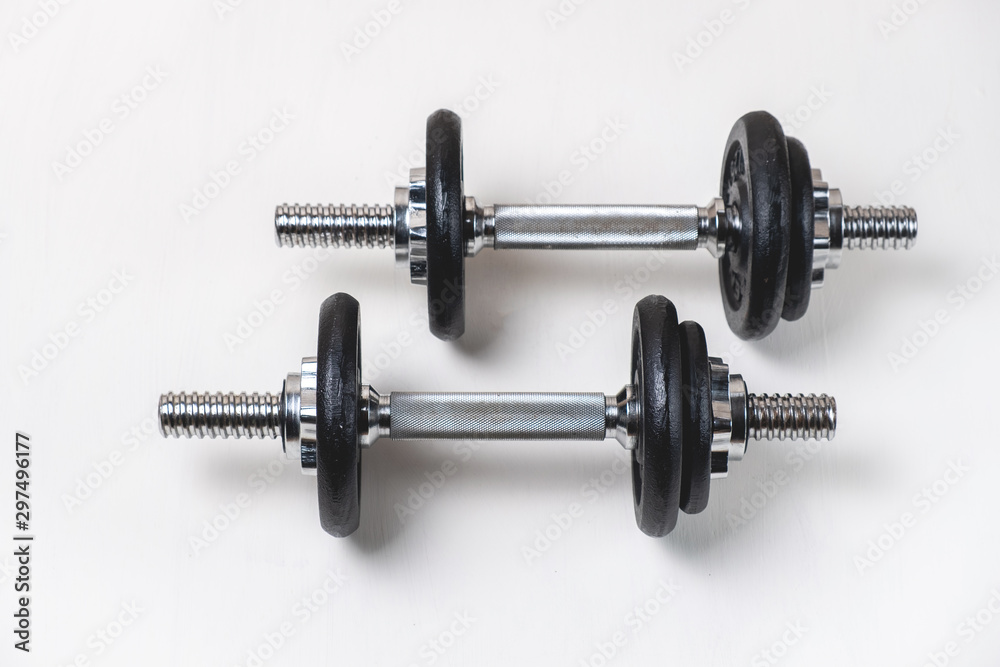 Sports dumbbells with removable weights on a white background Sports dumbbells with removable weights on a white background