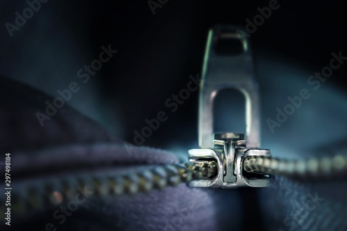 metal zipper macro shot, incisive technical invention for sewing and clothing industries, dark blue-grey background with copy space, selected focus